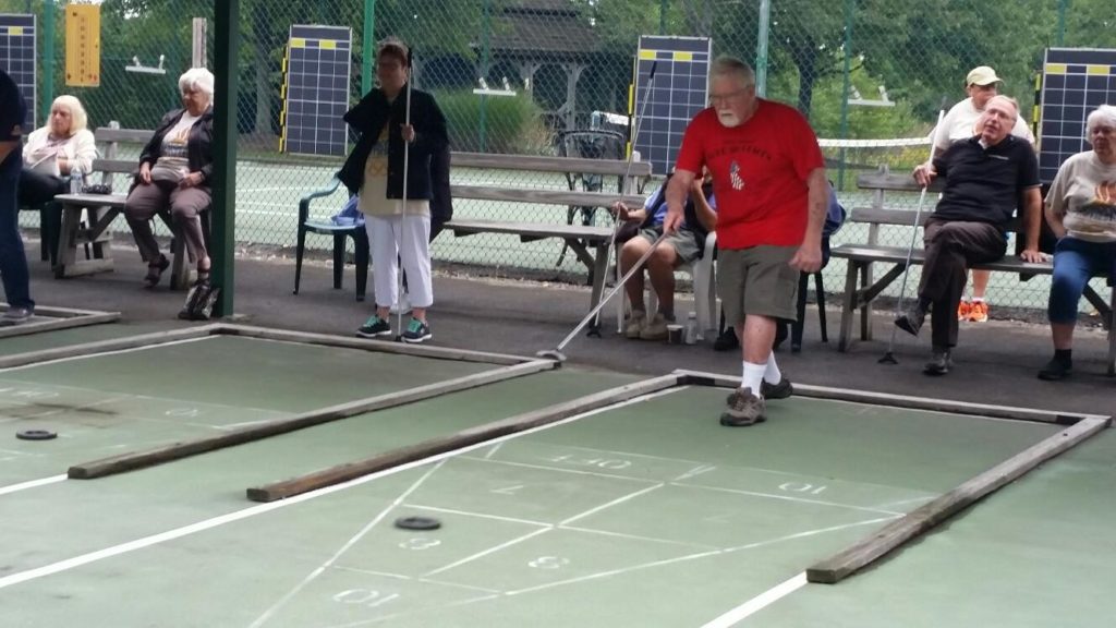 Resident at Glen Arden retirement community playing shuffle board